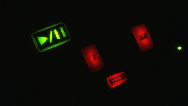 A close up shot of an electronic beat sequencer with animated lights in the dark. HD 1080p.