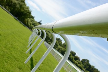 Fence at a horse race track on a sunny day