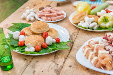 Table with food and drink ready for barbecue party