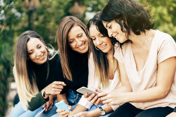 Big Group of friends using cellphones.