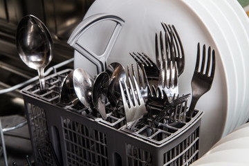 Steel forks and plates in dishwasher machine