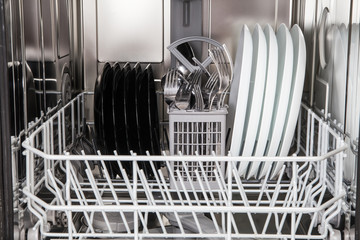 Dishes after washing in modern dishwasher machine