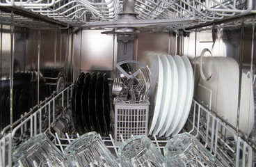 Dishes after cleaning in dishwasher machine