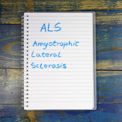 ALS Amyotrophic Lateral Sclerosis diagnosis written in notebook