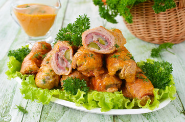 Meat rolls stuffed with bacon and pickled cucumber