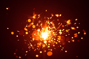 Obraz premium Christmas sparkler in haze with red light