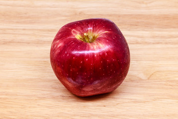 Fresh red apple on wood background.