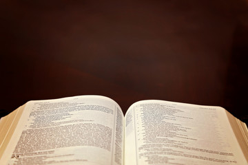 Fototapeta premium Holy Bible Open on a Wooden Table