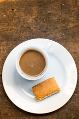 Coffee cup with sweets on the table brown.