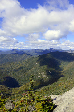 Alpine view from summit of a 46er with vast forests clouds and wilderness in the Adirondack Mountains, New York State