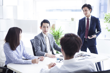 Four businessmen are meeting in a stylish office