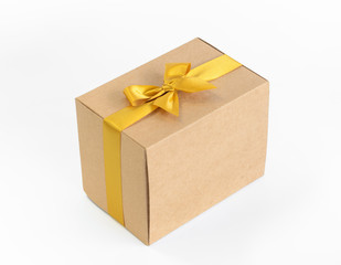 Gift box with gold bow on white background