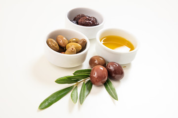 Olives and olive oil on white background