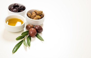 Olives and olive oil on white background