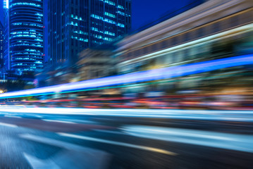 Obraz premium blurred traffic light trails on road at night in China.