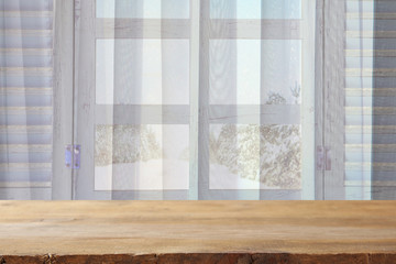 window sill and curtains in front of winter snow landscape
