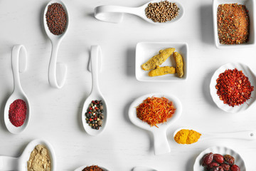 Flat lay of assorted herbs and spices on white background