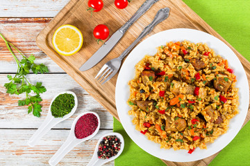 rice with meat, pepper, vegetables and spices on dish