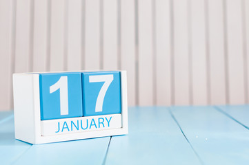 January 17th. Day 17 of month, calendar on wooden background. Winter time. Empty space for text