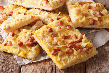 Pie with onions, bacon and cheese close-up. horizontal
