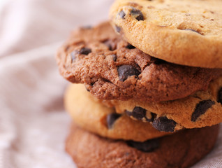 Fresh oat biscuits with chocolate on napkin, closeup