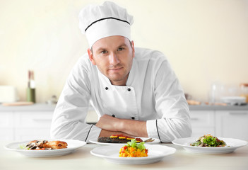 Young chef cook with different dishes in kitchen