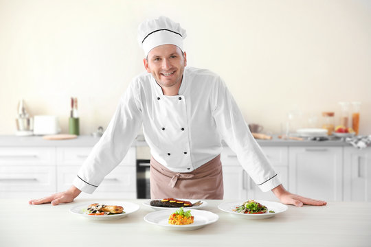 Young chef cook with different dishes in kitchen