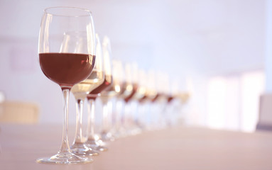 Glasses with red and white wine on table in restaurant