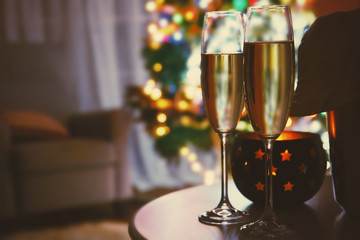 Two glasses of champagne on blurred background, close up view