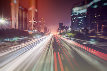 Fototapeta na wymiar blurred traffic light trails on road at night in China.