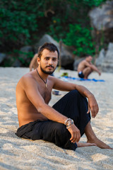 Fototapeta na wymiar Man sitting on a beach