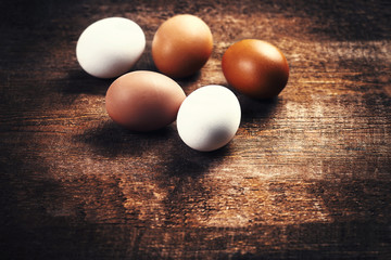 ..Farm eggs on a wooden rustic background. Fresh brown and white