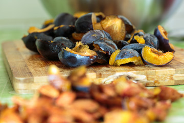 Plums sliced on a wooden board