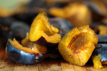 Plums sliced on a wooden board