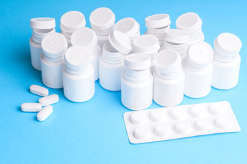 Many pills and tablets isolated on light blue background