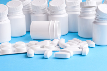Many pills and tablets isolated on light blue background