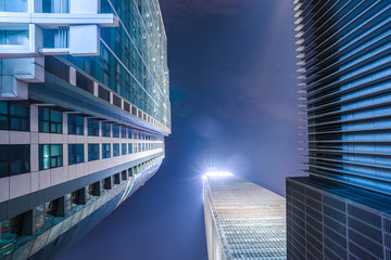 Fototapeta na wymiar Modern Buildings Against Sky at night.