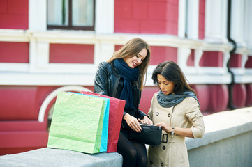 happy girls ,watch something in the bag after a shopping trip