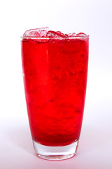 Red sweet drink on ice cubes isolated on white background