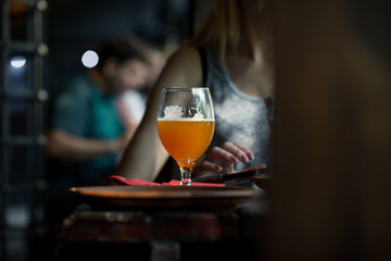 Half full glass of fresh wheat beer