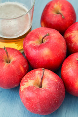 Ripe red apples with a glass of cider