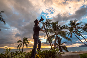 Tiki Torch Maintenance at Sunset on Island