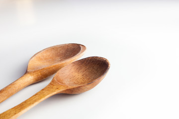 Two wooden spoons isolated on white background