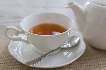 Afternoon tea with red tea on wooden table.