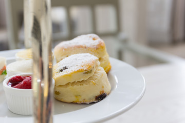 Luxury afternoon tea with dessert on wooden table.