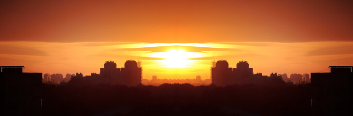 Fototapeta premium Beautiful evening cityscape. Aerial view. Skies, hazy sun, skyline, horizon. Selective focus. Special light. Wide panoramic image. 
