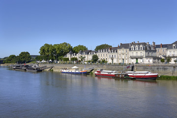 Fototapeta na wymiar Barges and boats on the Maine river at Angers, a commune in the Maine-et-Loire department, Pays de la Loire region, in western France 