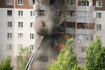 Firefighters extinguish a fire in multistory apartment building