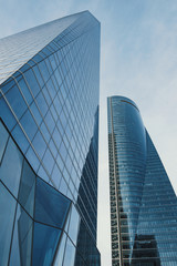Obraz na płótnie Canvas modern skyscrapers in business district against blue sky