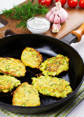 Zucchini Pancakes With  Sour Cream in Pan
